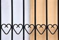 Wrought-iron railing with hearts in front of a wall Royalty Free Stock Photo