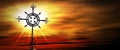 Wrought Iron Religious Cross against a Beautiful Sunset with Sunbeams Royalty Free Stock Photo