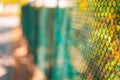 Abstract green iron fence with sunset light. Sport courts outdoor activity concept Royalty Free Stock Photo