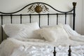 wroughtiron bed with white linen and lace