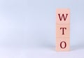 WTO on wooden cubes on a blue background