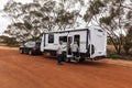 Wubin, WA, Australia - Aug 23, 2020: A retired couple enter their caravan at a roadside rest bay while touring during the