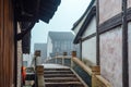 WUZHEN,CHINA-MARCH 6,2012: Ancient bridge over the canal . Morning fog over the city Royalty Free Stock Photo