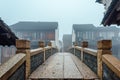 WUZHEN,CHINA-MARCH 6,2012: Ancient bridge over the canal . Morning fog over the city Royalty Free Stock Photo