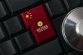 Wuhan chinese virus alert concept: a black computer keyboard with chinese flag enter key to spread an alert