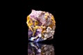 Wulfenite on a bedrock, black background, molybdate mineral gems