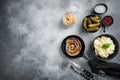 Wurst or Bratwurst with Fermented Cabbage  Pickled Cucumbers  and Spices in cast iron frying pan  on gray background  top view Royalty Free Stock Photo