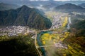 Landscape of a town surrounded by hills and rapeseed fields in Wuyuan, China