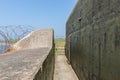 WW2 concrete shelter with barbwire near Kornwerderzand at Dutch Afsluitdijk