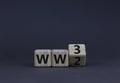 WW3 world war 3 symbol. Turned the wooden cube and changed the concept word WW2 to WW3. Beautiful grey table grey background, copy