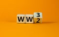 WW3 world war 3 symbol. Turned the wooden cube and changed the concept word WW2 to WW3. Beautiful orange table orange background,