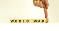 WW3 world war 3 symbol. Turned the wooden cube and changed the concept word World War 2 to World War 3. Beautiful white table