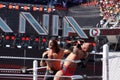 WWE Wrestler Seth Rollins pushes Randy Orton into the corner wit