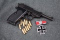 WWII era nazi german army 9 mm semi-automatic pistol with Iron Cross award Royalty Free Stock Photo