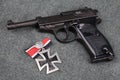 WWII era nazi german army 9 mm semi-automatic pistol with Iron Cross award Royalty Free Stock Photo