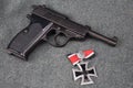 WWII era nazi german army 9 mm semi-automatic pistol with Iron Cross award Royalty Free Stock Photo