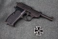 WWII era nazi german army 9 mm semi-automatic pistol with Iron Cross award Royalty Free Stock Photo