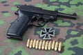 WWII era nazi german army 9 mm semi-automatic pistol with Iron Cross award Royalty Free Stock Photo