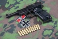 WWII era nazi german army 9 mm semi-automatic pistol with Iron Cross award Royalty Free Stock Photo