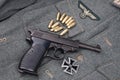 WWII era nazi german army 9 mm semi-automatic pistol with Iron Cross award Royalty Free Stock Photo