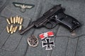 WWII era nazi german army 9 mm semi-automatic pistol with Iron Cross award Royalty Free Stock Photo