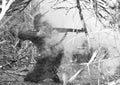WWII Soldier Firing M1 Rifle Through Smoke