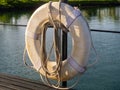 Safety equipment life buoy or rescue buoy hanging on a rail ready to save sailor