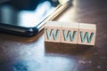 WWW Written On Wooden Blocks Next To A Smartphone On A Table Royalty Free Stock Photo