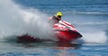 Jet Ski competitor cornering at speed creating at lot of spray. Royalty Free Stock Photo