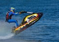 Jet Ski racer going over jump at speed. Royalty Free Stock Photo