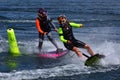 Two Female Motorsurf Competitors racing around course marker.