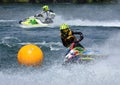 Jet Ski  race competitor cornering at speed creating at lot of spray. Royalty Free Stock Photo