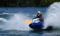 Jet Ski  race competitor cornering at speed creating at lot of spray. Royalty Free Stock Photo