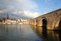 Wyck neighborhood  Sint Martinuskerk church and the 13th century roman bridge Sint Servaasbrug viewed from Meuse river Royalty Free Stock Photo