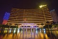 Wynn Macau at night with many colourful lights decorating the surrounding & beautiful water reflection