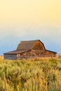 Wyoming Moulton Barn with Tetons and summer grass and smokey haze