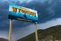 A Wyoming State welcome sign with mountains on the background in Western USA