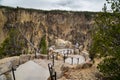 Tourist man enjoys the view from Inspiration Point at the Grand Canyon of the Yellowstone