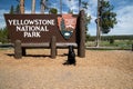 Welcome sign for Yellowstone National Park, at the south entrance. Black labrador retriever dog