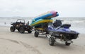 A 4x4 car pulling a rickshaw on the beach of Si Racha