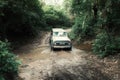 4x4 car vehicle crossing a small stream of river at the jungle rainforest Royalty Free Stock Photo