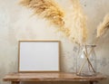 30x40 cm photo frame with pampas grass in a large jar on a bench near the wall