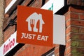 "Just Eat" sign on the wall of Amico Restaurant on the High Street, Billericay, Essex, UK