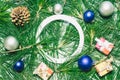 X-mas with Christmas balls, presents, pinecones and green pine leaves. Empty circle copy space for text Royalty Free Stock Photo