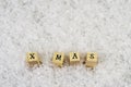 X mas word made of letters on wooden cubes on a snow background 2 Royalty Free Stock Photo