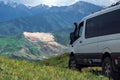 4x4 offroad van Mersedes-benz Sprinter on mountain valley. Off-road travel, journey in motorhome concept