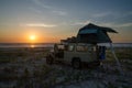 4x4 offroad vehicle with roof top tent camping on beach during sunset, Casamance, Senegal, Africa Royalty Free Stock Photo