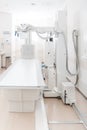 X-ray department in modern hospital. Radiology room with scan machine with empty bed. Technician adjusting an x-ray Royalty Free Stock Photo