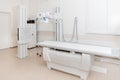 X-ray department in modern hospital. Radiology room with scan machine with empty bed. Technician adjusting an x-ray Royalty Free Stock Photo