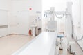 X-ray department in modern hospital. Radiology room with scan machine with empty bed. Technician adjusting an x-ray Royalty Free Stock Photo